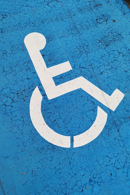 Parking space with wheelchair symbol on blue background for accessibility.